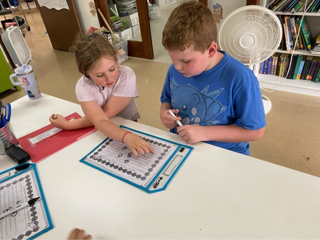 Two elementary students work together at micro school.