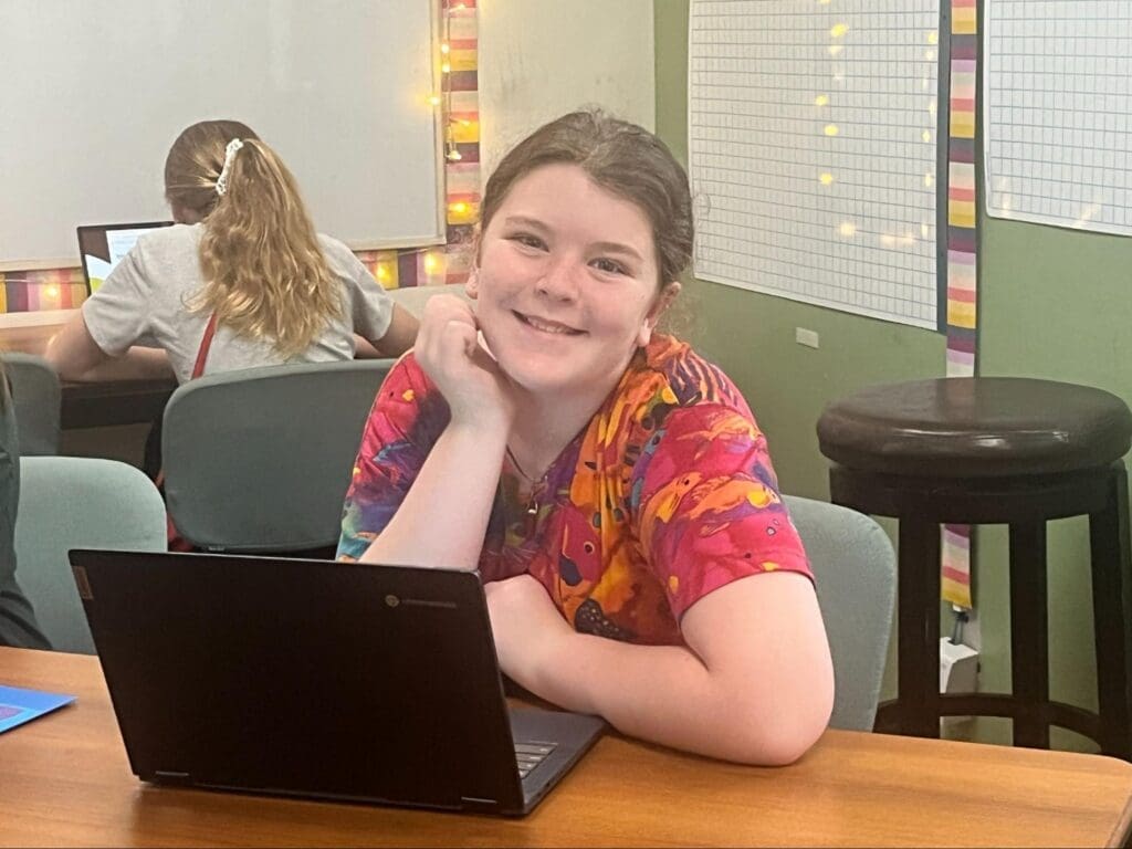 Middle school student works on computer at GT school.