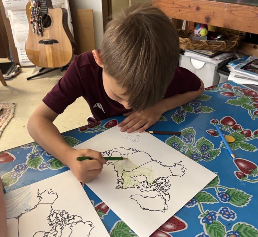 Kindergarten student works on geography at private school in Austin.