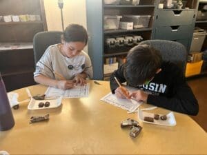 Two middle school students work at table at STEM school in Austin.