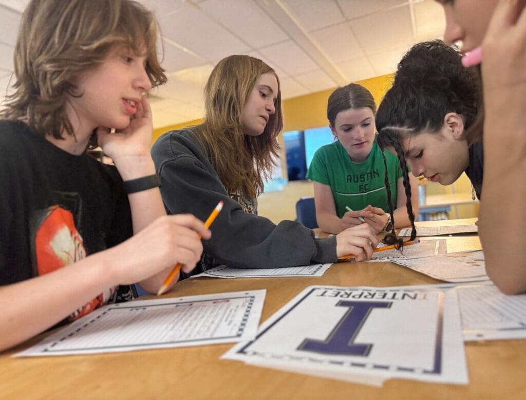 Middle school students work together at school with small classes.