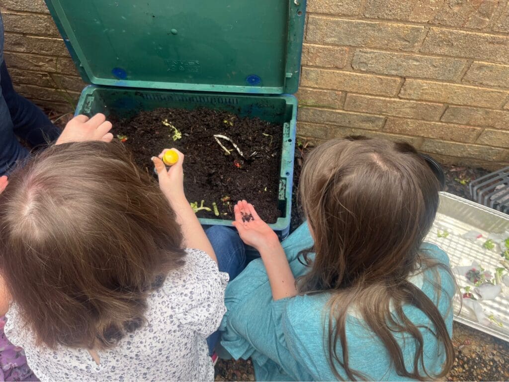 Elementary students work with dirt at project based school.