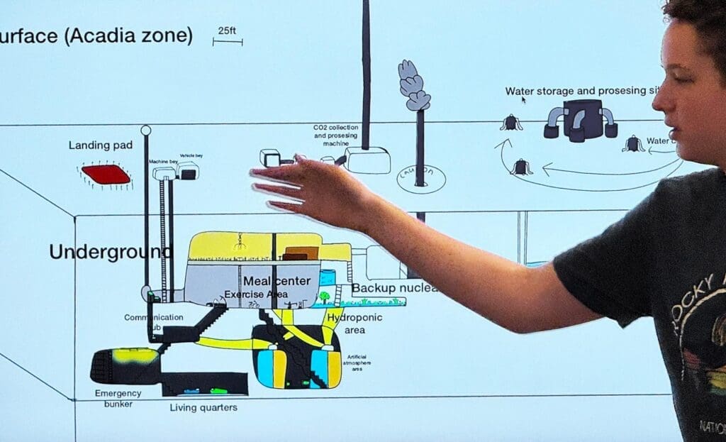 Middle school student explains graphic at micro school.