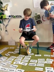 Elementary student reads to class at micro school in Austin.