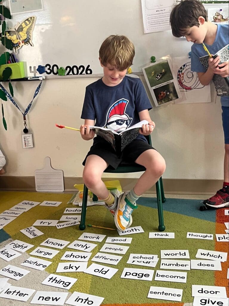 Elementary student reads to class at micro school in Austin.