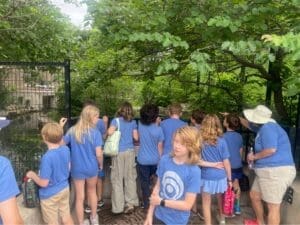 Elementary students explore park on field trip at nonreligious school.