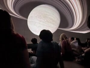 Middle school students participate in on campus planetarium at private school in Austin.