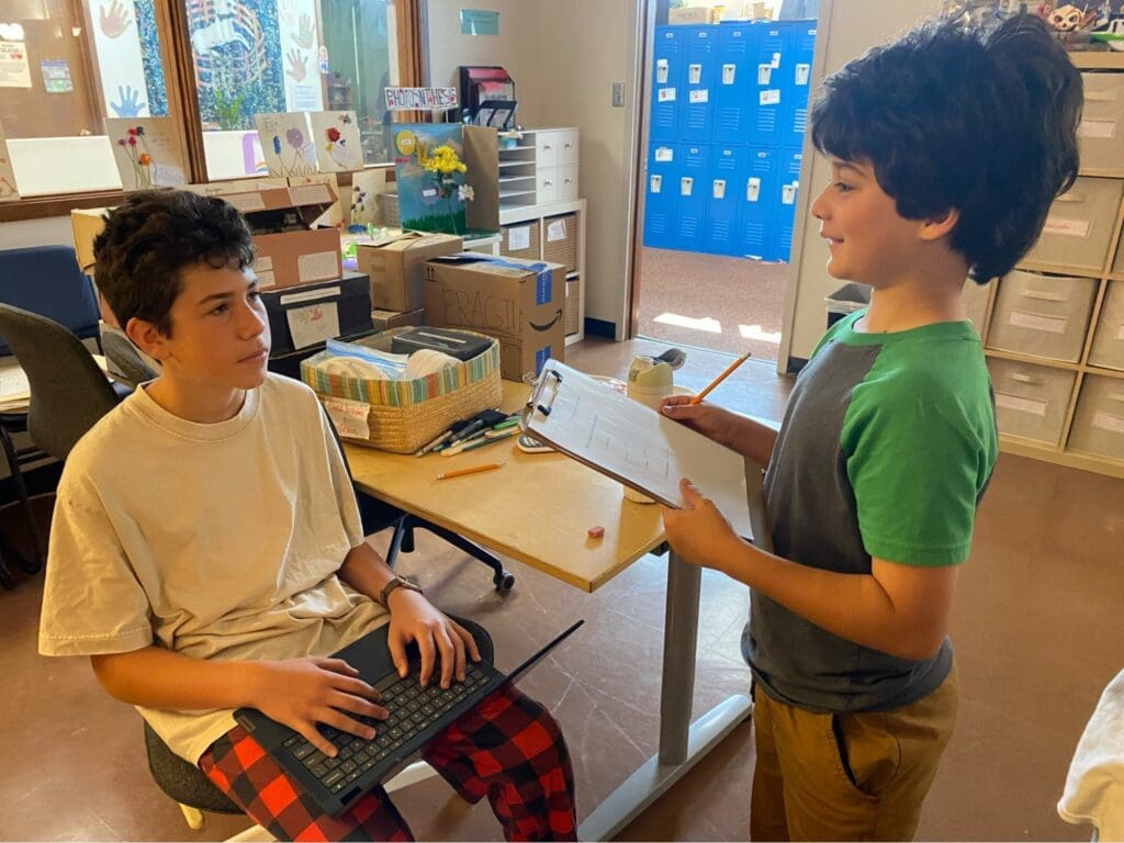 Elementary student interviews middle schooler at micro school.